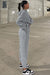 Set of plain gray sports clothes with hooded sweatshirt and jogging pants with falling shoulders