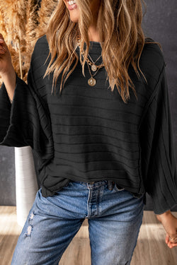 Dolman Pull in black ribbed knitting with exposed seams