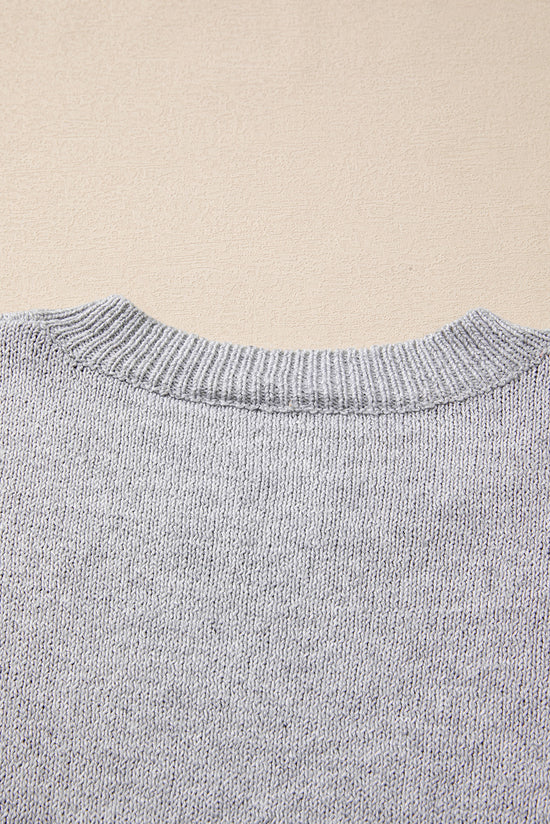 Pull gris à épaules tombantes et motif étoiles