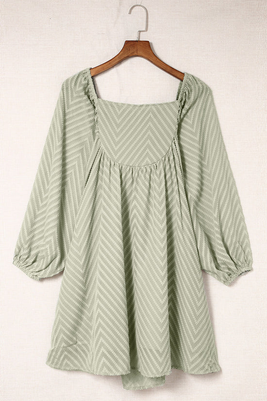 Short babydoll style dress with puffed sleeves and square neck