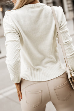 White textured knit sweater with decorative buttons