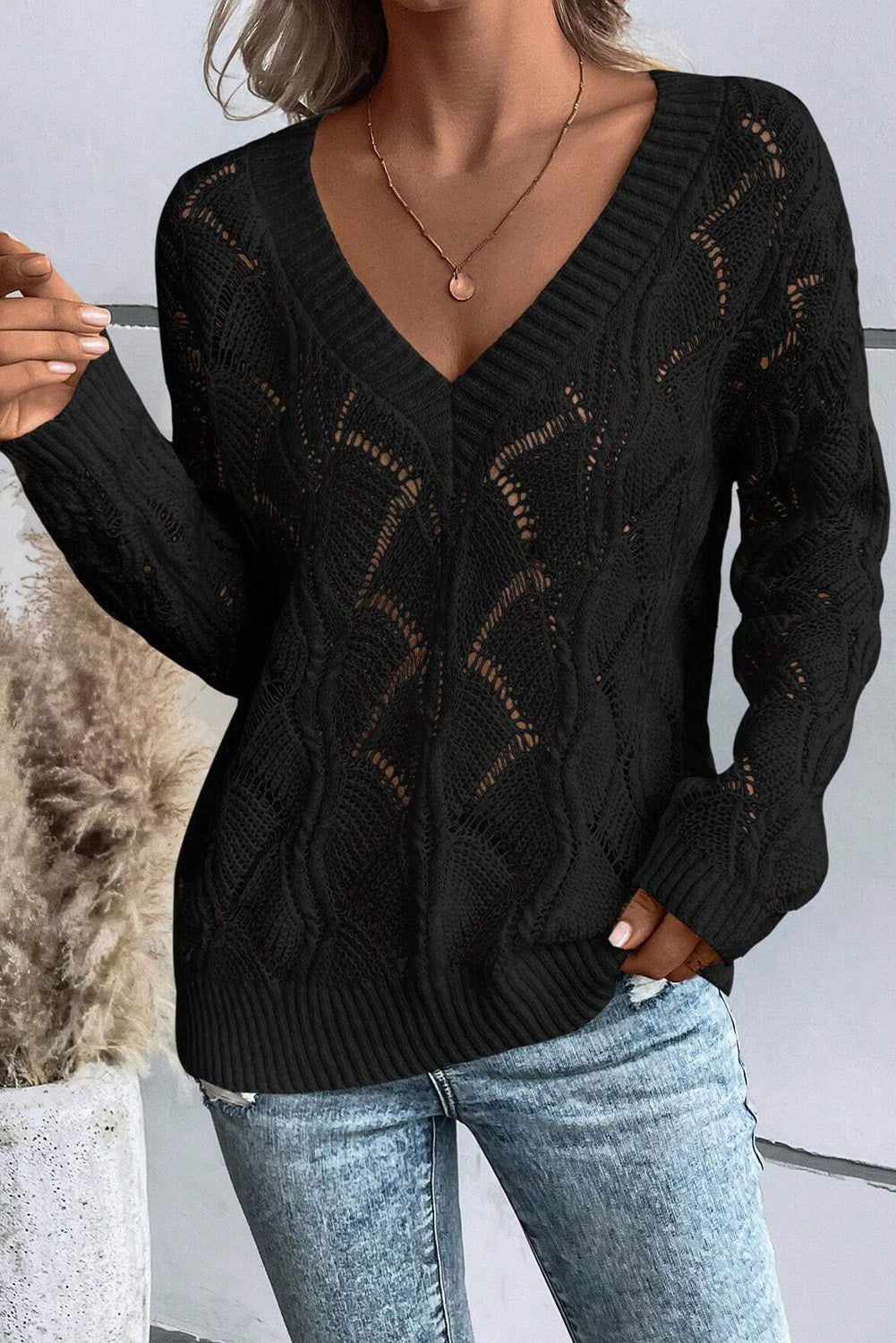 Black openwork knit sweater with V-neck and dropped shoulders