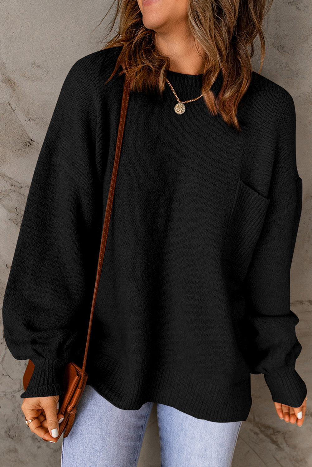 Black sweater with puff sleeves and solid color pockets