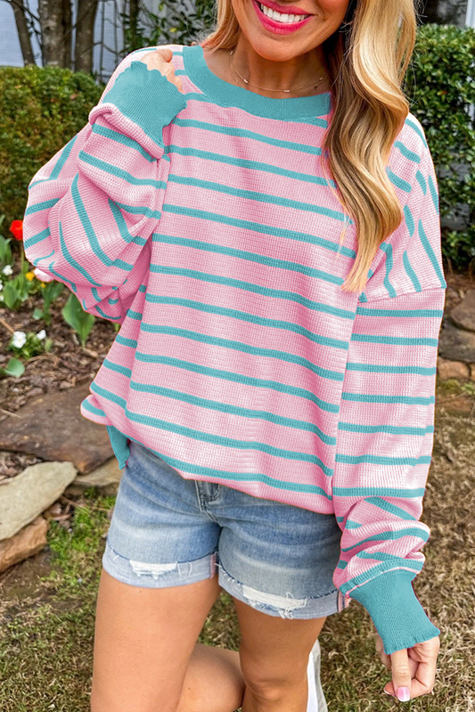 Loose sweater with pink stripes and round neck, dropped shoulders