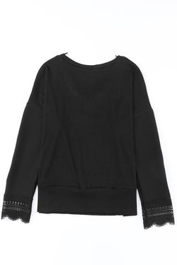 Black long sleeve v-neck top with lace trim and ribbed texture