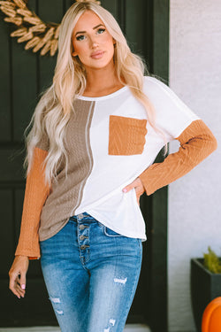 Orange textured knit top with long sleeves and color block chest pocket