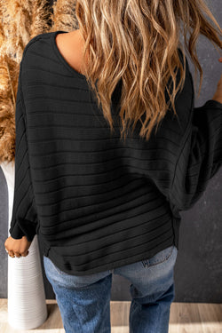 Dolman Pull in black ribbed knitting with exposed seams