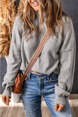 Grey turtleneck knit sweater with dropped shoulders and bubble sleeves