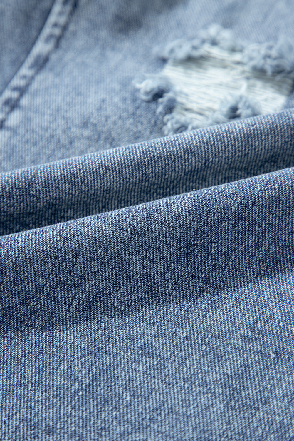 Salopette en jean bleu pierre effet vieilli avec poche à bavette et jambe large