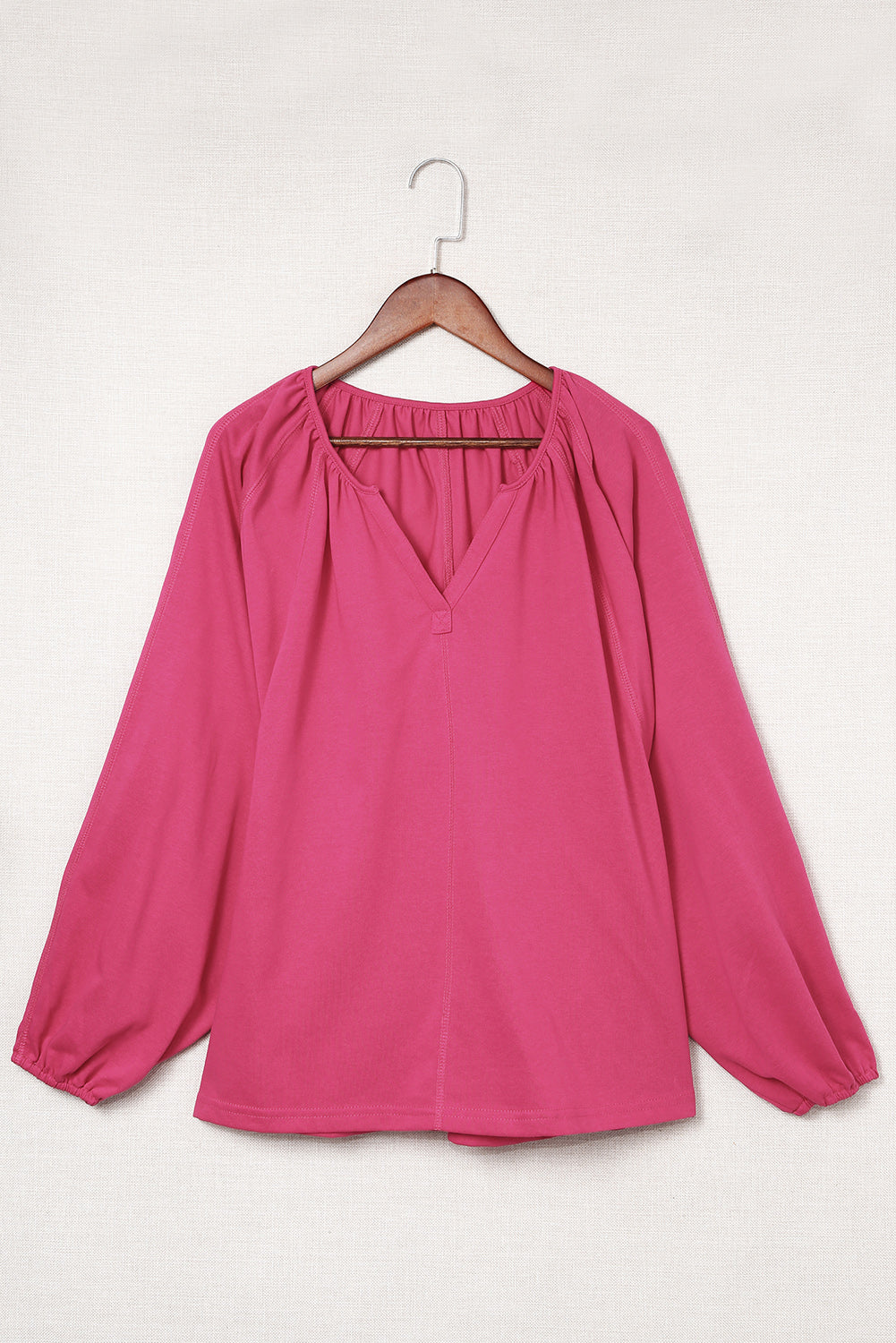 Haut dolman rose fendu à col en V