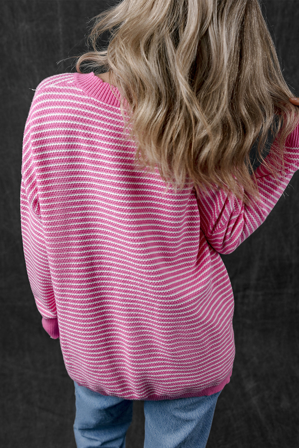 Loose V-neck sweater with pink striped slits