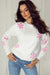 Elegant ribbed sweater with white flower pattern