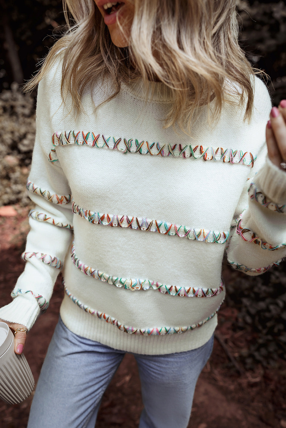 Colorful white sweater with dropped shoulders and crossed stitches