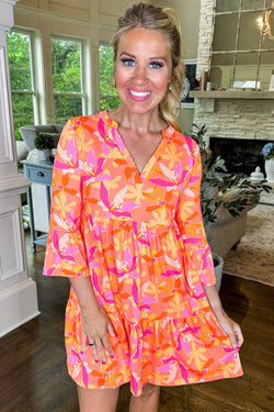 Orange dress with abstract print and ruffled sleeves, V-neck