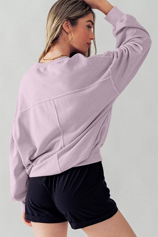 Dropped shoulder sweatshirt with batwing sleeves and exposed seams and orchid petals