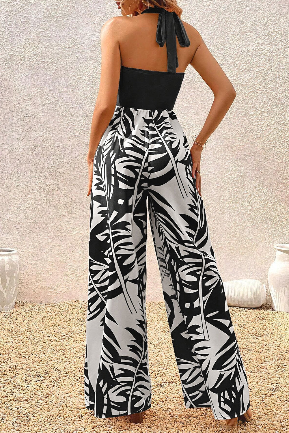 Black wide leg jumpsuit with tropical plant print