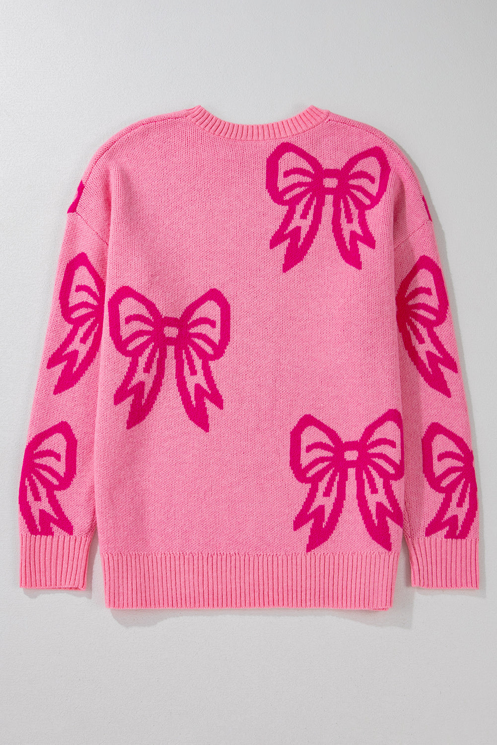 Pull ample rose à épaules tombantes et motif nœud