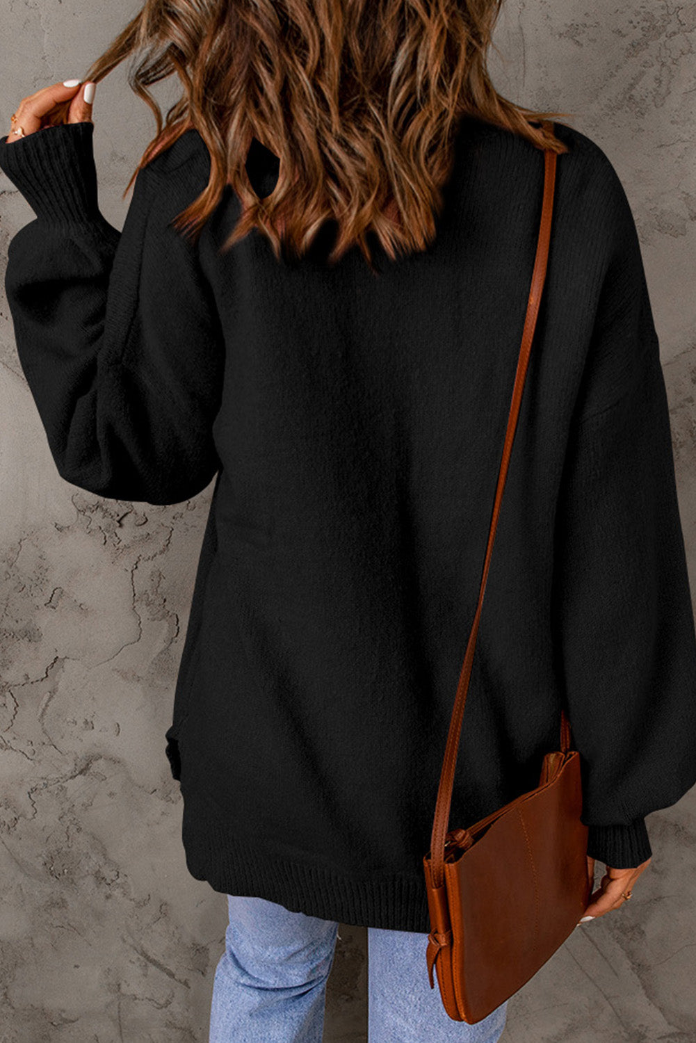 Black sweater with puff sleeves and solid color pockets