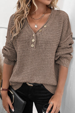 Khaki tricot sweater buttoned with V -neck button and drooping shoulders