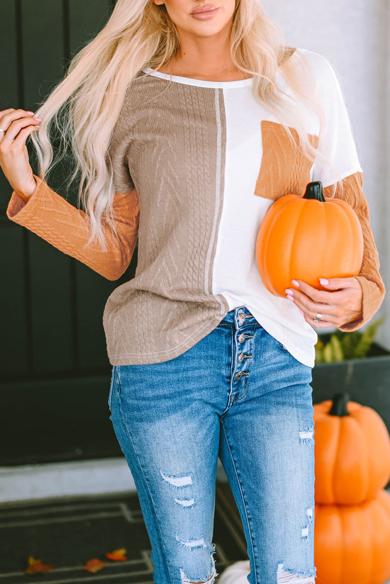 Orange textured knit top with long sleeves and color block chest pocket