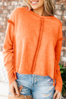 Orange raw edge sweatshirt with exposed seams, top and bottom