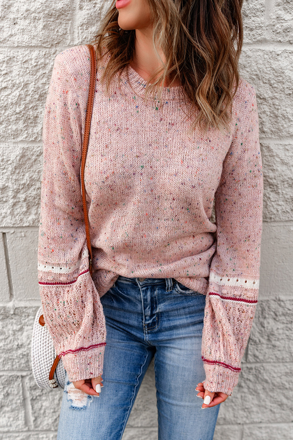 Pink sweater with patterned sleeves and pilled details