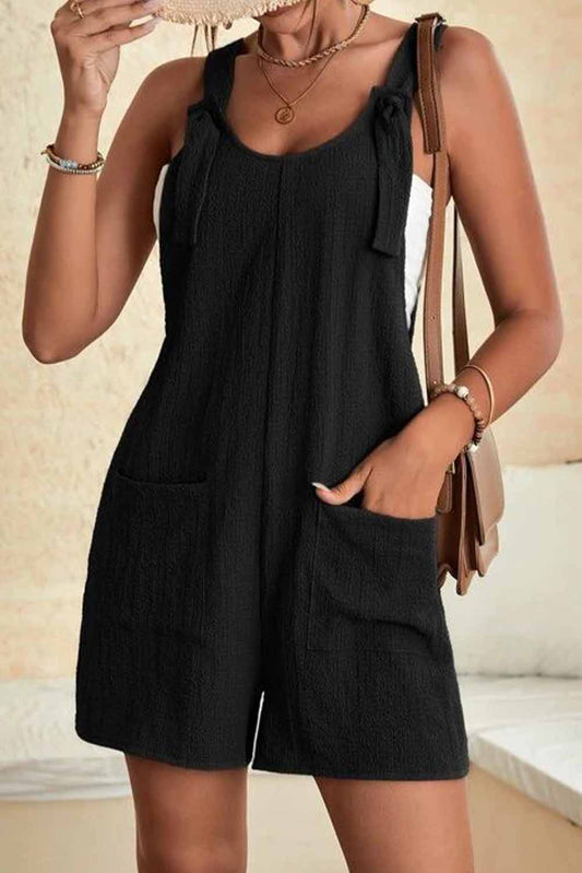 Black textured romper with adjustable straps and pockets