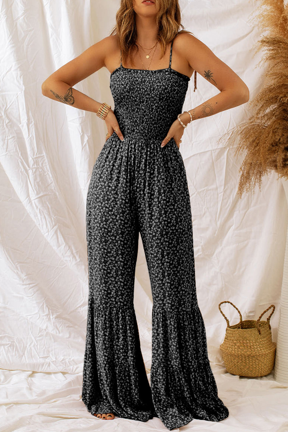 Black floral jumpsuit with thin straps and smocked bodice