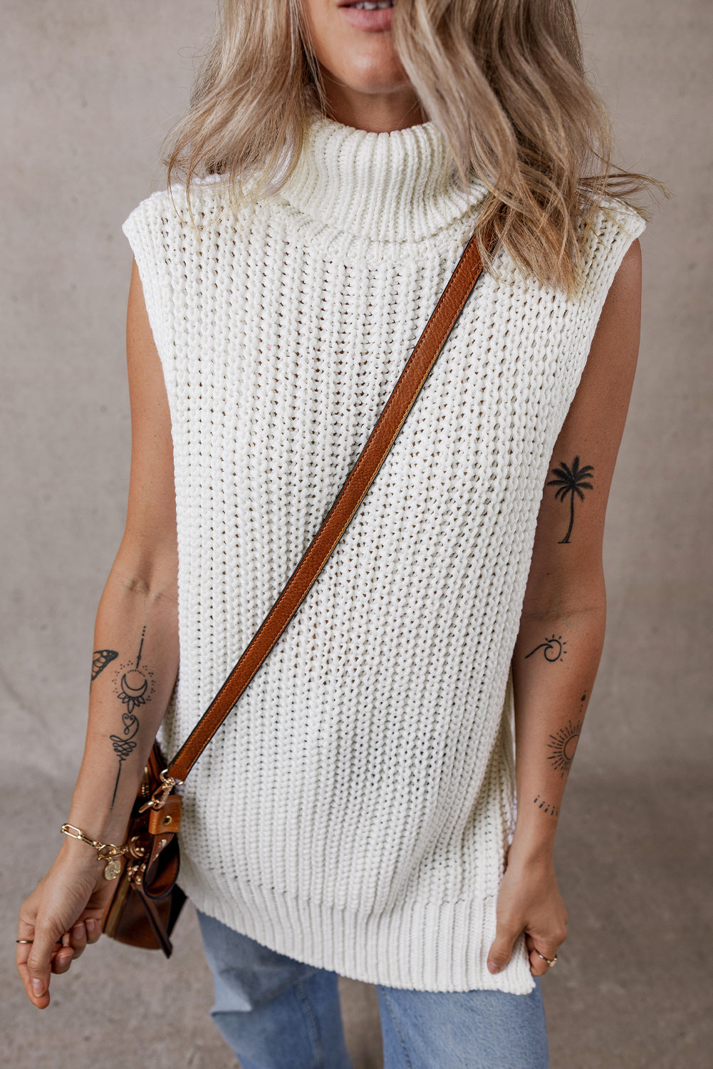 White sweater vest with turtleneck and split hem