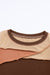 Brown ribbed knit top with exposed seams and color blocking