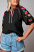 Blusa con textura negra con mangas hinchadas y bordado floral Ricrac