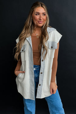 Light grey jacket with flap pockets and contrasting buttons on the front