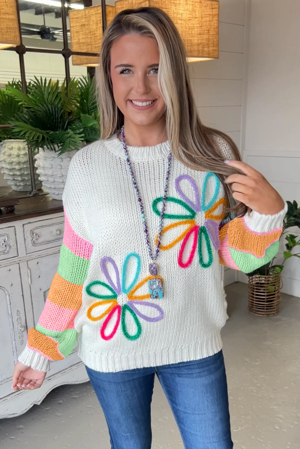 Crew neck sweater with color block sleeves and white floral pattern