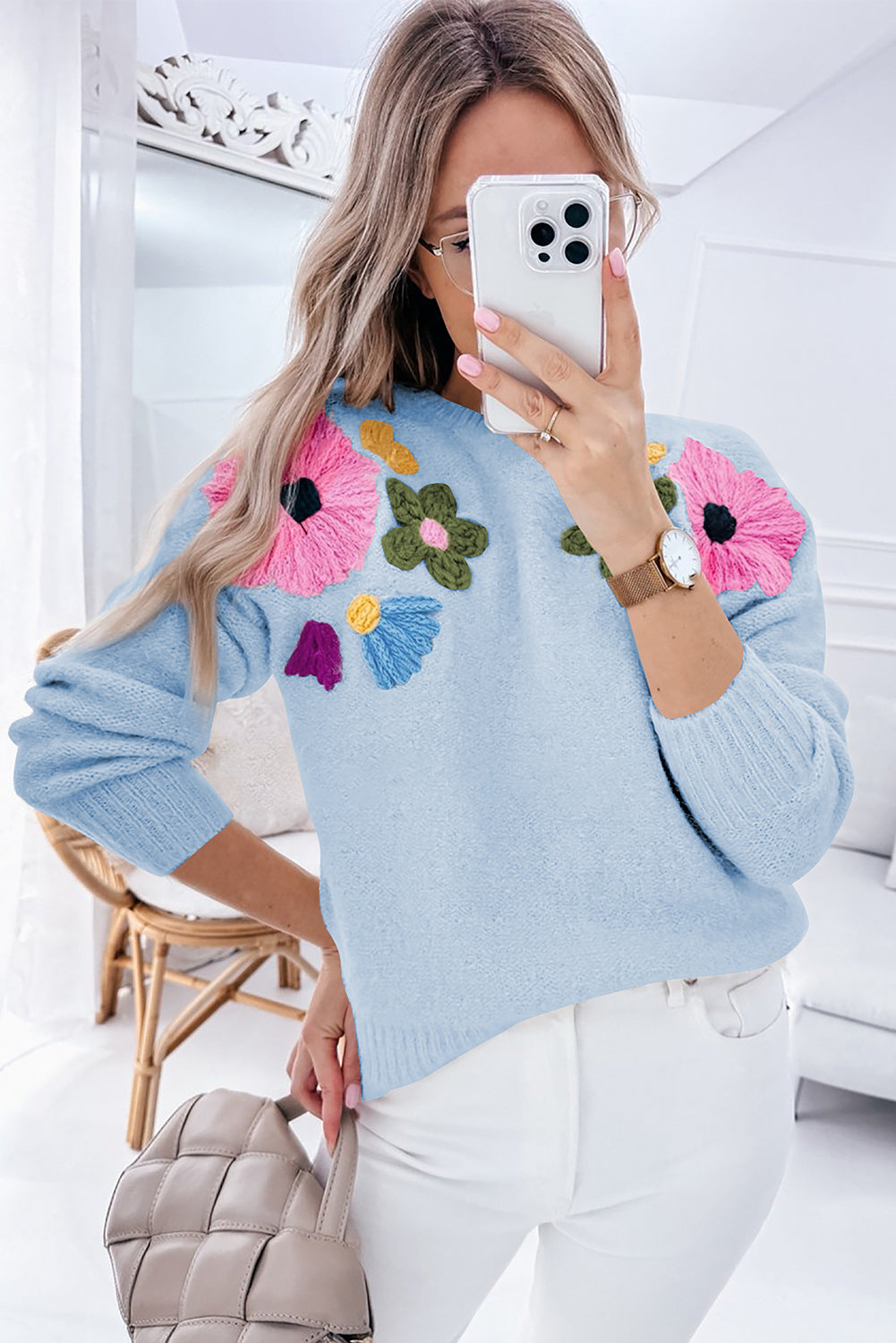 Light blue knitted sweater with ribbed edges and floral pattern