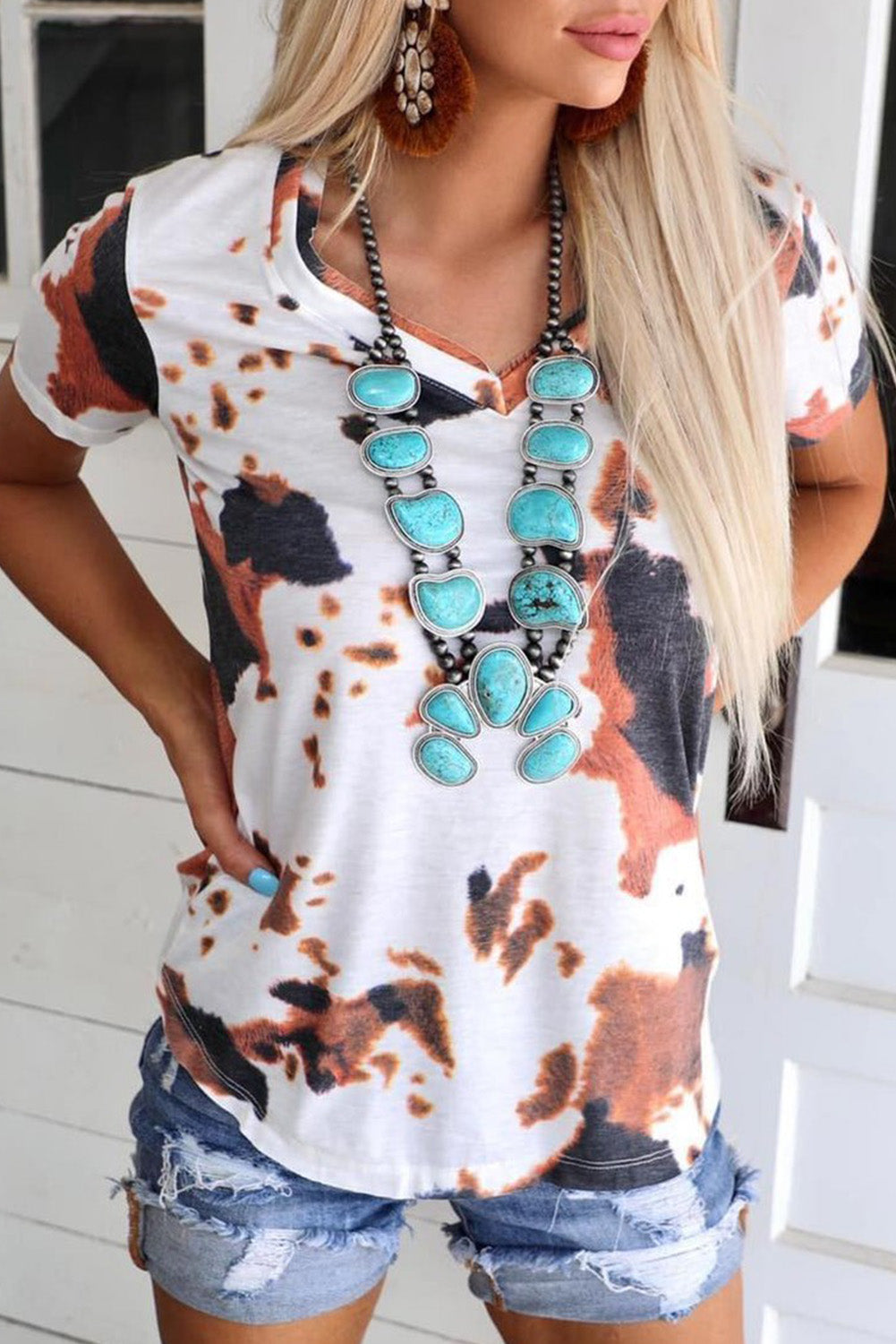 White T-shirt with short sleeves and V-neck printed with cow pattern