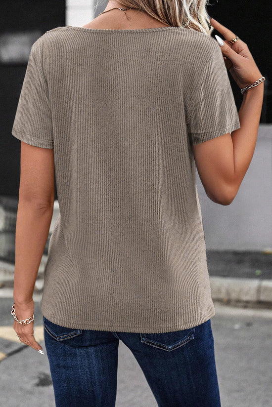 Pale chopped khaki t-shirt with buttoned suspenders and v-collar