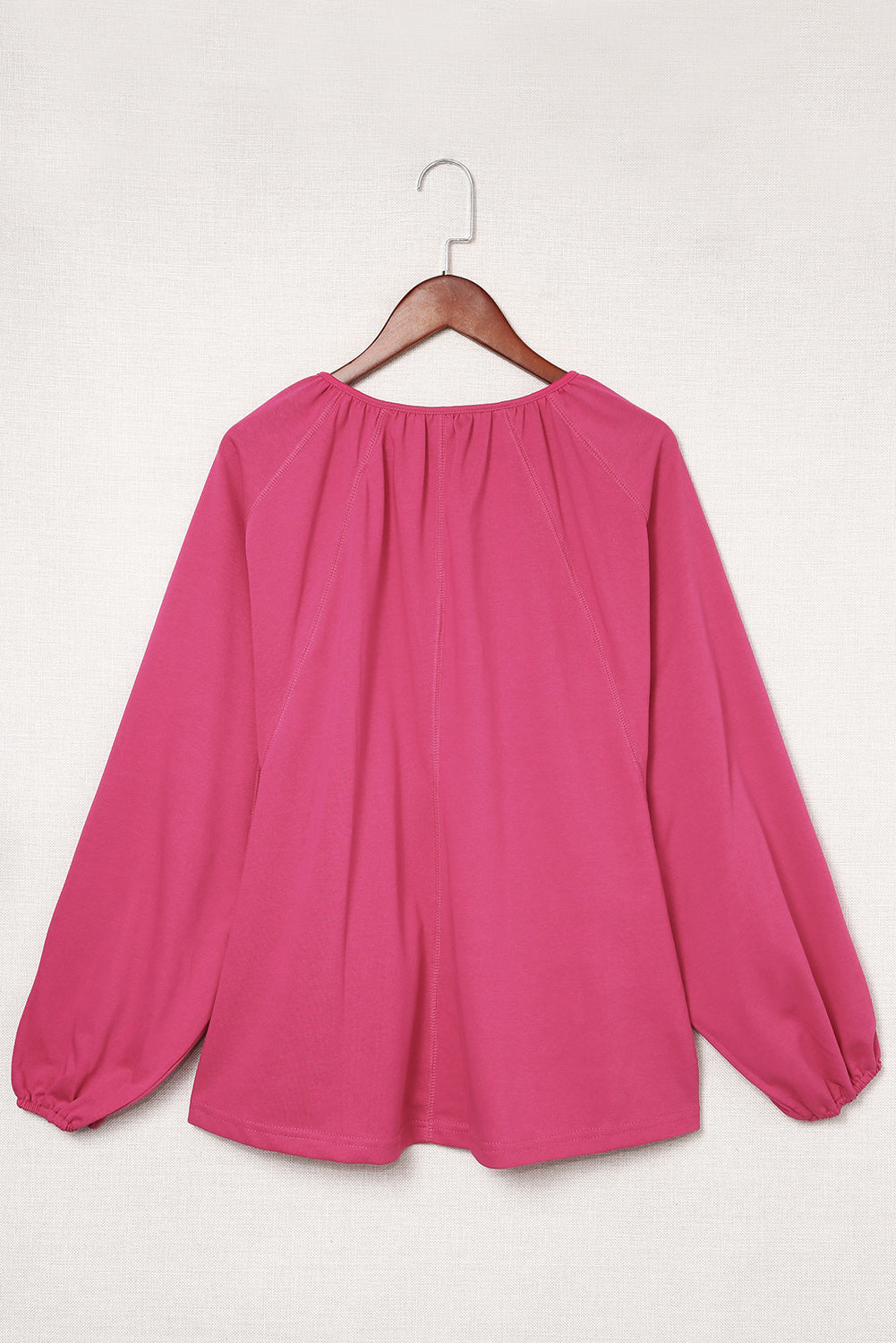 Haut dolman rose fendu à col en V