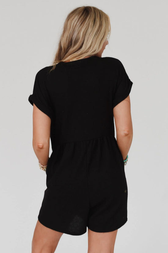 Black short sleeve romper with loose lapels with buttons and V-neck