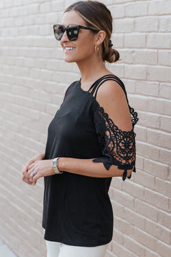 Black top with bare shoulders and lace straps