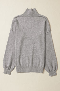 Grey turtleneck knit sweater with dropped shoulders and bubble sleeves