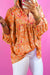 Babydoll orange blouse in V -collar and abstract print