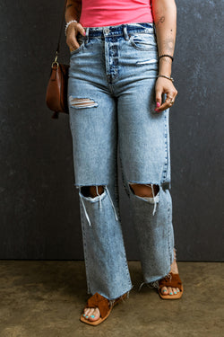 Light blue right jeans torn and torn in raw hem