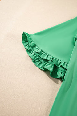 Green blouse with ruffles, round neck *