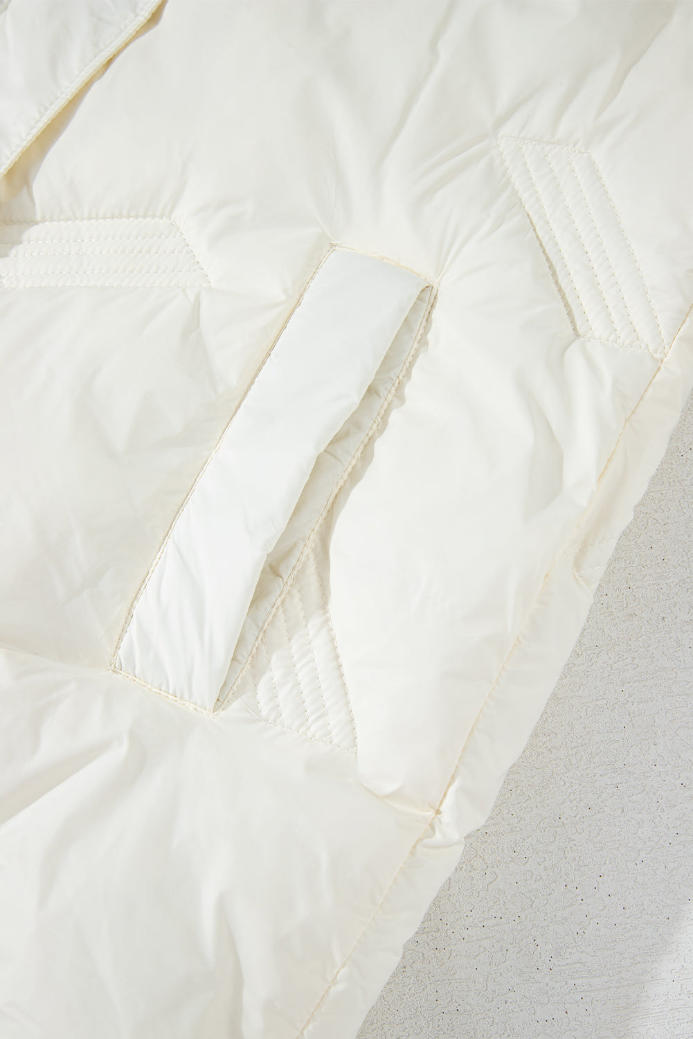 White quilted jacket with high collar and zipper