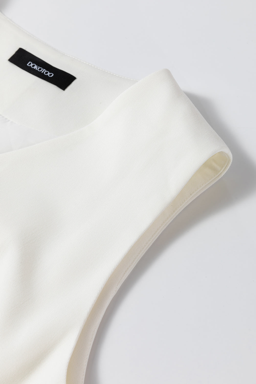 White costume vest with united buttoned V -neck colored