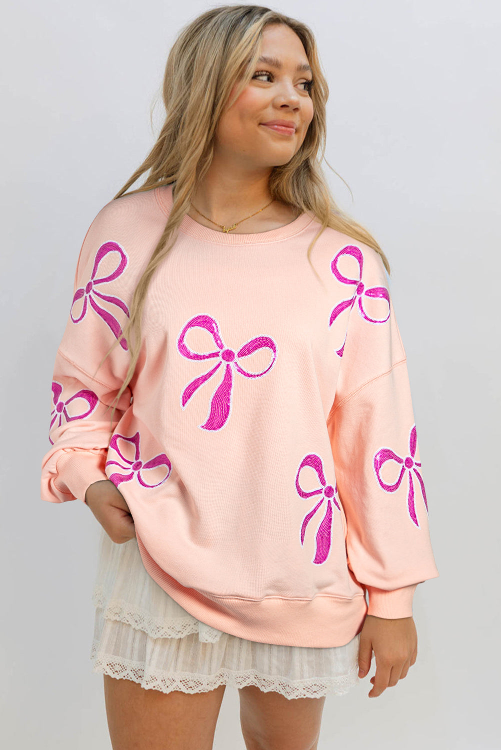 Sweat-shirt surdimensionné rose abricot à paillettes et nœud papillon à épaules tombantes