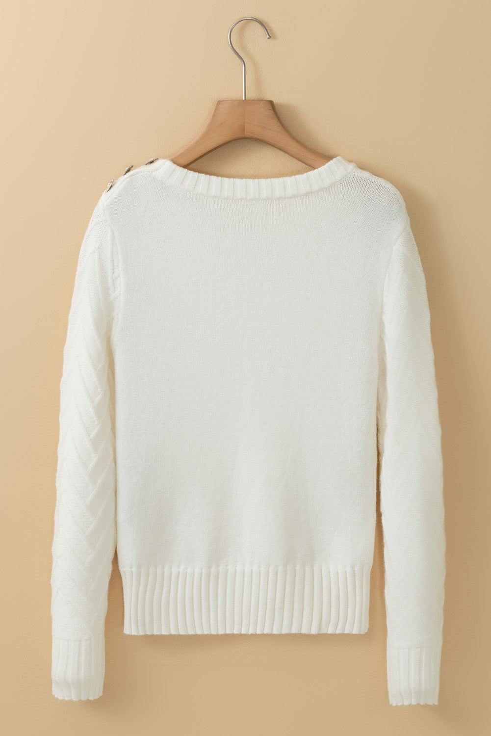 White textured knit sweater with decorative buttons