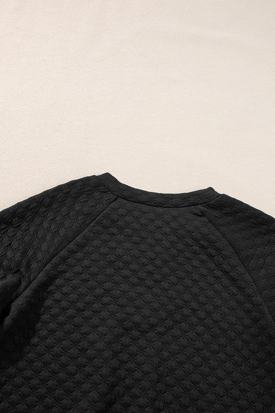 Black quilted top with long sleeves and split collar