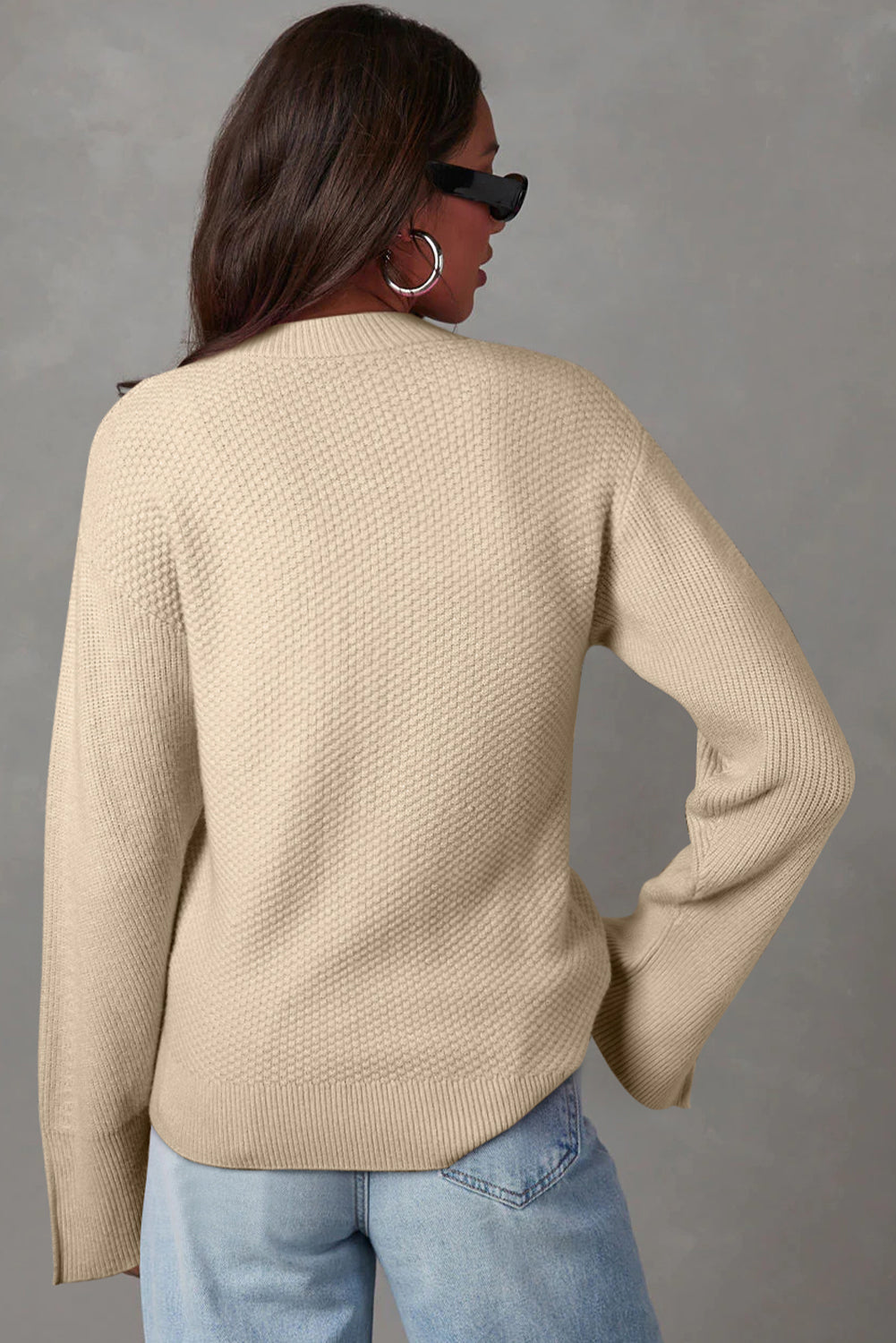 Loose-fitting parchment textured knit sweater with slit cuffs and dropped shoulders