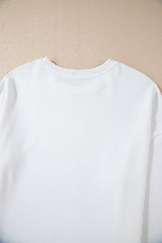 White loose sweatshirt with bow tie pattern and dropped shoulders